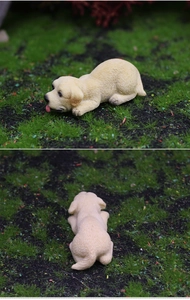 Detailed resin Labrador puppy figurine showing realistic fur texture and playful pose