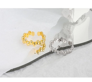 Close-up of gold and silver S925 beaded open rings with irregular oval bean shapes