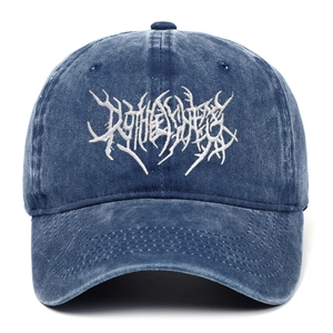 Detail of white 3D gothic embroidery on washed navy blue cotton denim baseball cap