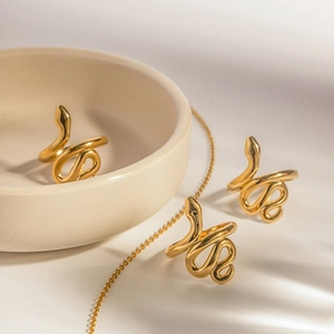 Golden snake-shaped open rings in polished titanium steel for a modern minimalist look