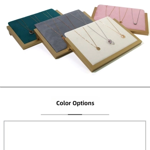 Detail view of multi-color velvet jewelry display trays with gold metal frames for necklaces