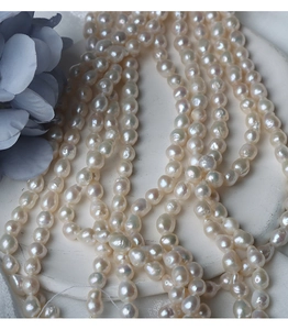 Macro shot of irregular 6.5-7mm baroque freshwater pearls with iridescent cream luster