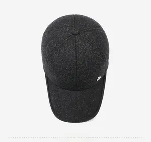 Top down view of dark grey winter baseball cap showing textured wool fabric and metal logo