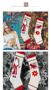 Macro shot of knitted Christmas stockings with Santa patterns and 3D floral appliques