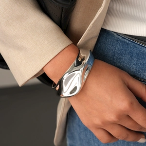 Close-up of irregular liquid metal style silver cuff bracelet on model wrist