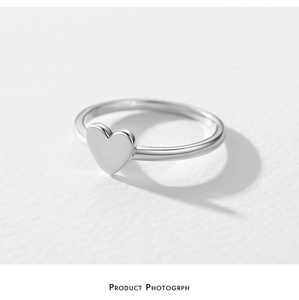 Detail shot of heart-shaped S925 sterling silver ring with a polished finish and hallmark