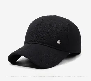 Detail of black winter baseball cap with textured wool fabric and silver shield logo
