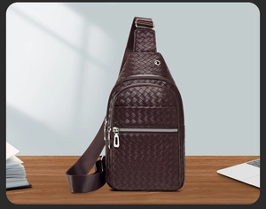 Detailed close-up of woven texture dark brown PU leather sling bag with silver zippers