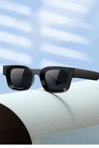 Detail shot of black thick-frame square sunglasses displayed on a soft blue background