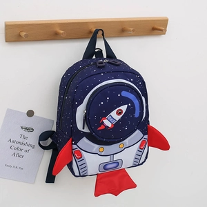 Detail view of navy blue space-themed backpack with transparent pocket and red wing accents