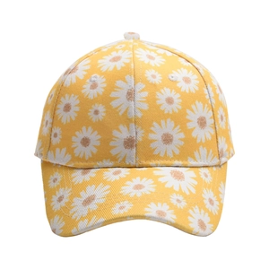 Close-up of yellow baseball cap featuring embroidered white daisy floral patterns