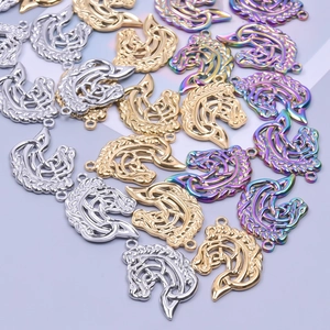 Detail of horse-shaped hollow charms in gold, silver, and rainbow stainless steel finishes