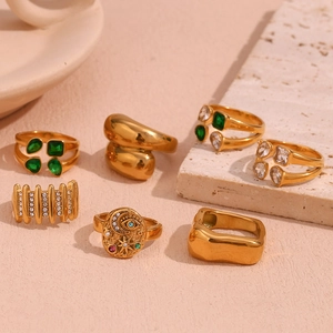 Collection of retro 18K gold plated stainless steel geometric rings on stone display