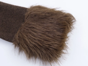 Detailed close-up of dark brown knit fabric with premium faux fur trim texture