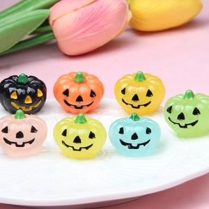 Luminous 3D resin Halloween pumpkin ornaments in seven vibrant colors on a white plate