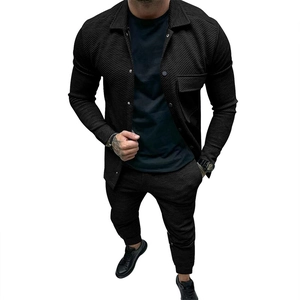 Close-up of the diagonal twill texture and chest pocket on a black men's jacket suit