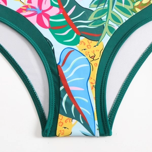 Detail of tropical jungle print bikini bottom with leopard head and floral pattern
