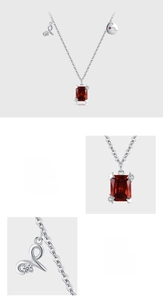 Macro view of 925 sterling silver necklace with large red zircon and star detailing