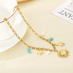 Detail of 18K gold stainless steel chain with sun, moon, turquoise and pearl charms