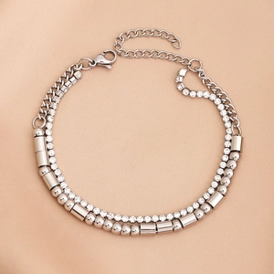 Detail of silver double-layered bracelet with zircon stones and metallic bead chain links