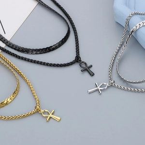 Detailed shot of double-layered stainless steel necklaces with Ankh cross pendants