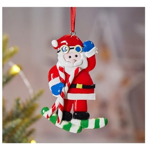 Detail of Santa Claus skiing ornament with red silk ribbon on festive background