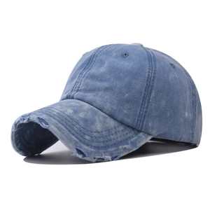 Retro washed blue denim baseball cap with distressed brim holes on white background