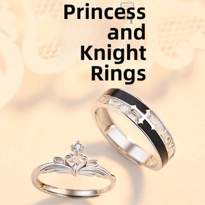 Macro shot of Princess crown and Knight cross pattern couple rings in silver finish