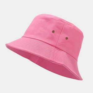 Detailed side view of pink cotton bucket hat with metal eyelets and stitched brim