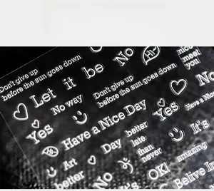 Close-up of 3D embossed transparent nail stickers with silver inspirational English quotes