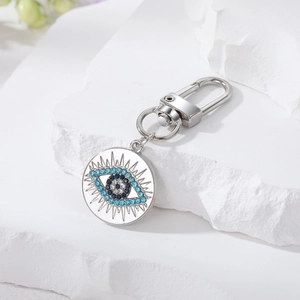 Macro view of vintage silver evil eye keychain with sparkling blue rhinestones inlay