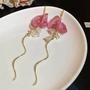 Detail of floral tassel earrings with pink fabric petals and white pearl lily beads