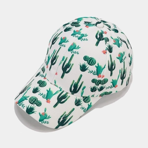 Close-up of tropical green cactus and pink floral print on white cotton baseball cap
