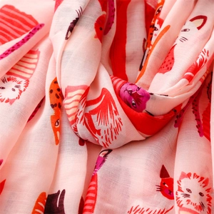 Close-up of lightweight satin cotton fabric with cute red and orange cat pattern prints