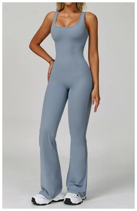 Detail of light blue yoga jumpsuit featuring a racerback neckline and flared leg design