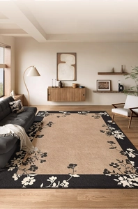 Close-up of vintage floral border on warm brown rectangle rug in a modern living room
