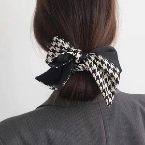 Elegant houndstooth and black satin bow hair tie for high-end French style low ponytail