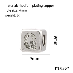 Macro detail of silver letter G charm with cubic zirconia inlay and 4mm large hole