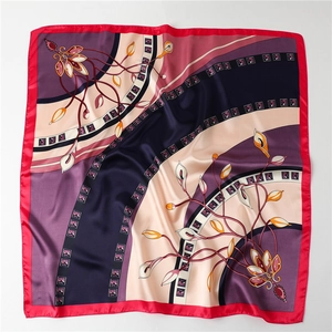 Detail of satin square scarf featuring floral patterns and silky smooth texture