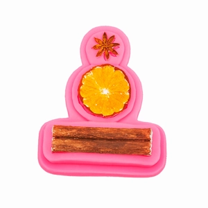 Pink silicone mold featuring star anise, lemon slice, and cinnamon stick shapes