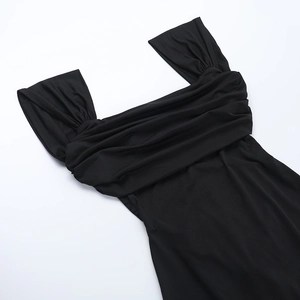 Detail shot of the ruched square neckline and wide straps of a black slim bodycon dress
