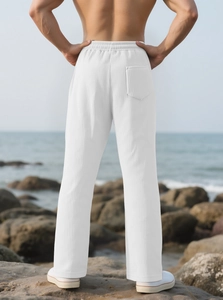 Detail of white corduroy wide-leg trousers showing back pocket and textured fabric finish