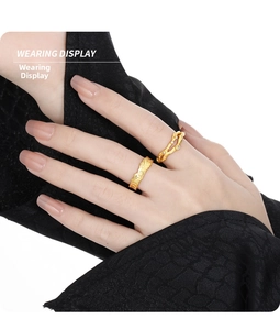 Detailed view of two gold-plated textured rings with micro-pave cubic zirconia on hand