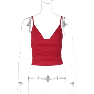 Detail shot of a red V-neck crop top with textured pleats on a white background