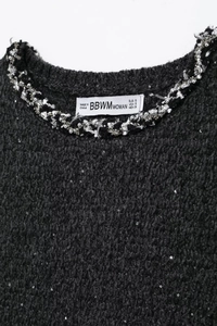 Detail of sequin tweed dress neckline with silver beads and woven trim decoration
