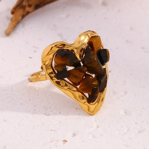 Detail of vintage 18K gold plated heart ring featuring tiger eye stone inlay texture