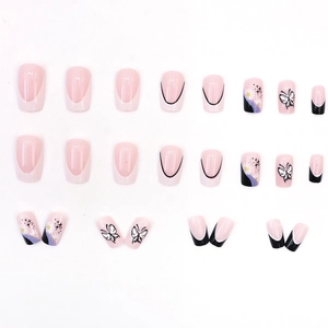 French press-on nails with black butterfly and white daisy designs on pink base