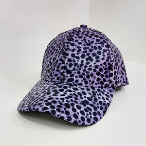 Detail view of purple leopard print baseball cap with glossy fabric and curved brim