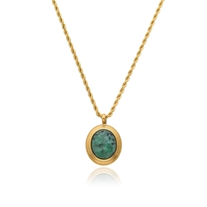 Detail of vintage gold rope chain necklace featuring an oval green stone pendant
