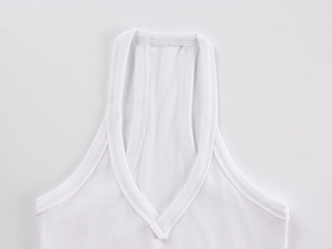 Close-up of white ribbed knit fabric detailing V-neck stitching on women's vest